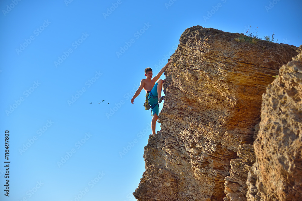 Fototapeta premium Extreme Climber Climbs On A Rock
