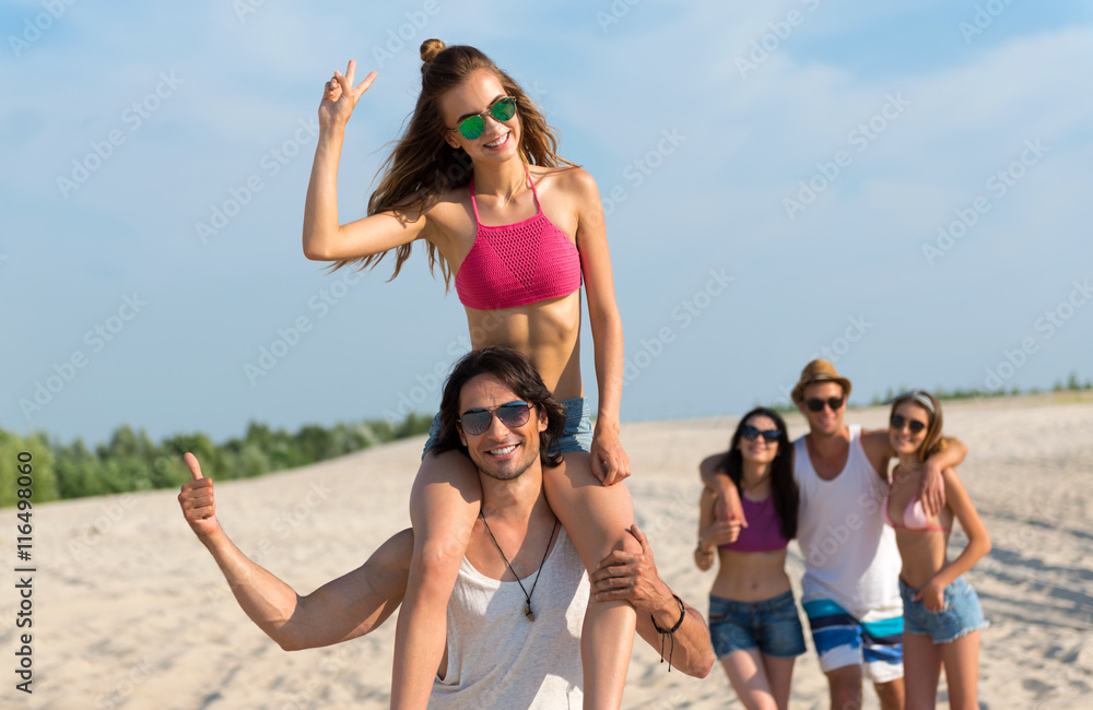 Delighted glad friends having fun on the beach Delighted glad friends having fun on the beach