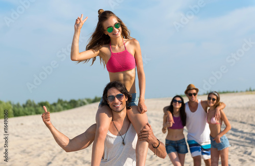 Delighted glad friends having fun on the beach © Viacheslav Yakobchuk