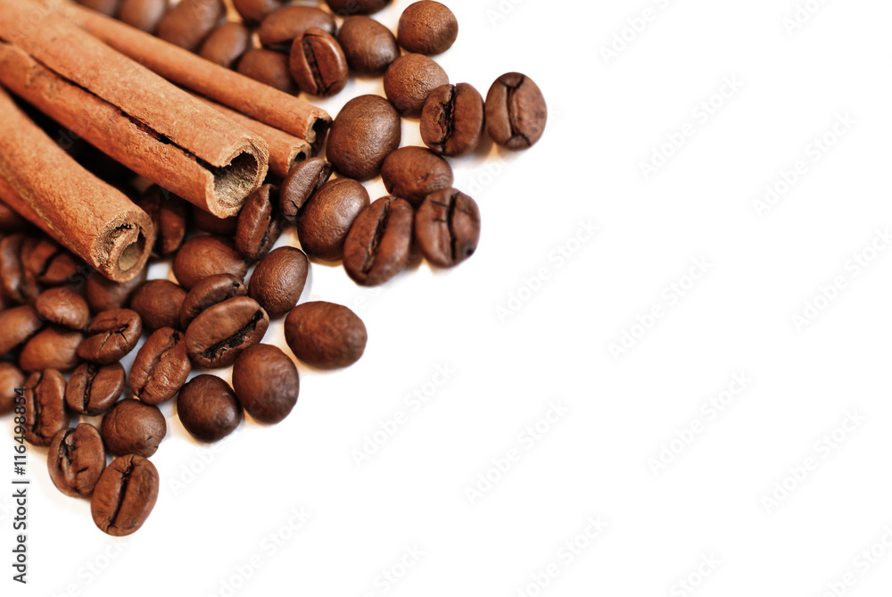 Coffee beans and cinnamon sticks isolated on white. Selective focus Coffee beans and cinnamon sticks isolated on white. Selective focus