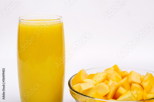 Fresh golden mango served with smoothie on white