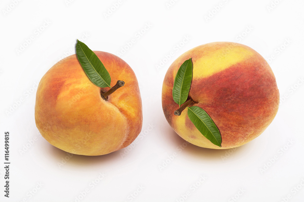 Two peach fruits with leaf isolated on white background Two peach fruits with leaf isolated on white background