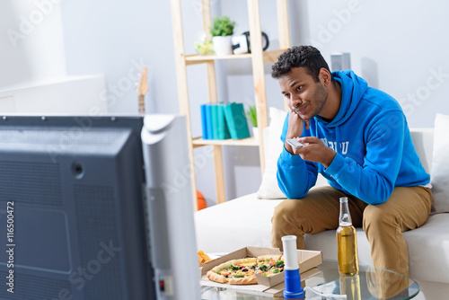 Konstfotografi Young attractive african man watching television