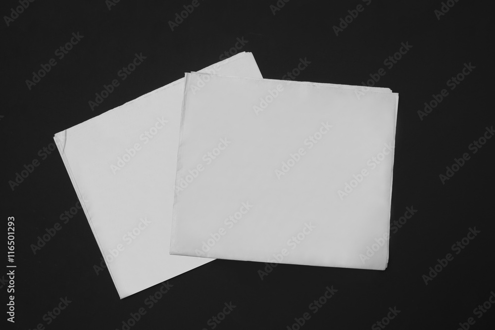 The MockUp of the newspaper on a black background The MockUp of the newspaper on a black background