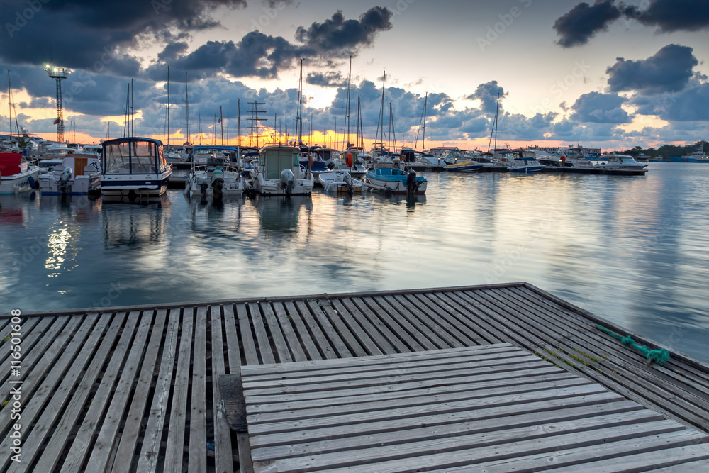 Obraz premium Sunset seascape with boats on the port of Sozopol, Burgas Region, Bulgaria