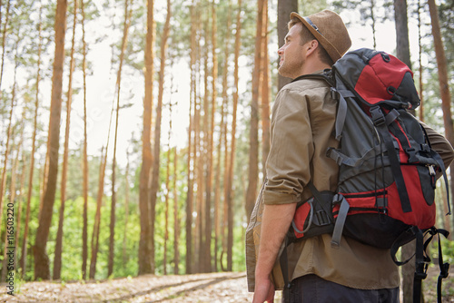 Wallpaper Mural Cheerful male adventurer walking in forest Torontodigital.ca