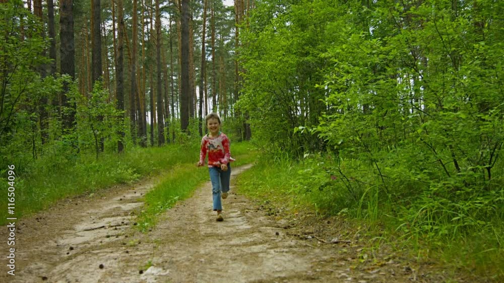 Video 1080p - Happy kid running along the road in a summer forest Video 1080p - Happy kid running along the road in a summer forest