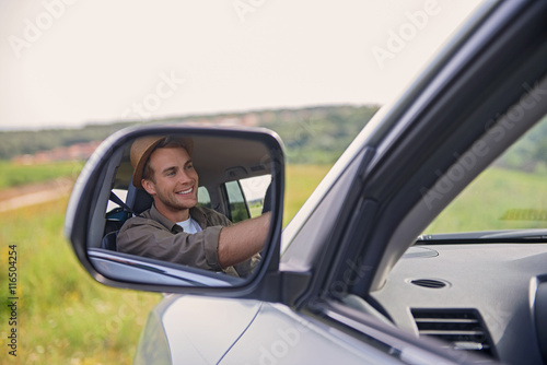 Joyful young man driving transport
