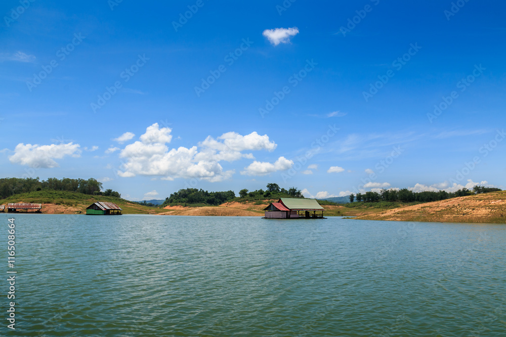 View riverside with blue sky,clouds and raft in countryside View riverside with blue sky,clouds and raft in countryside
