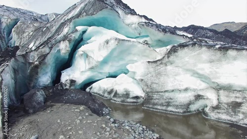 Aerial view of an outlet glacier in iceland in summer, melt water evident and great fissures