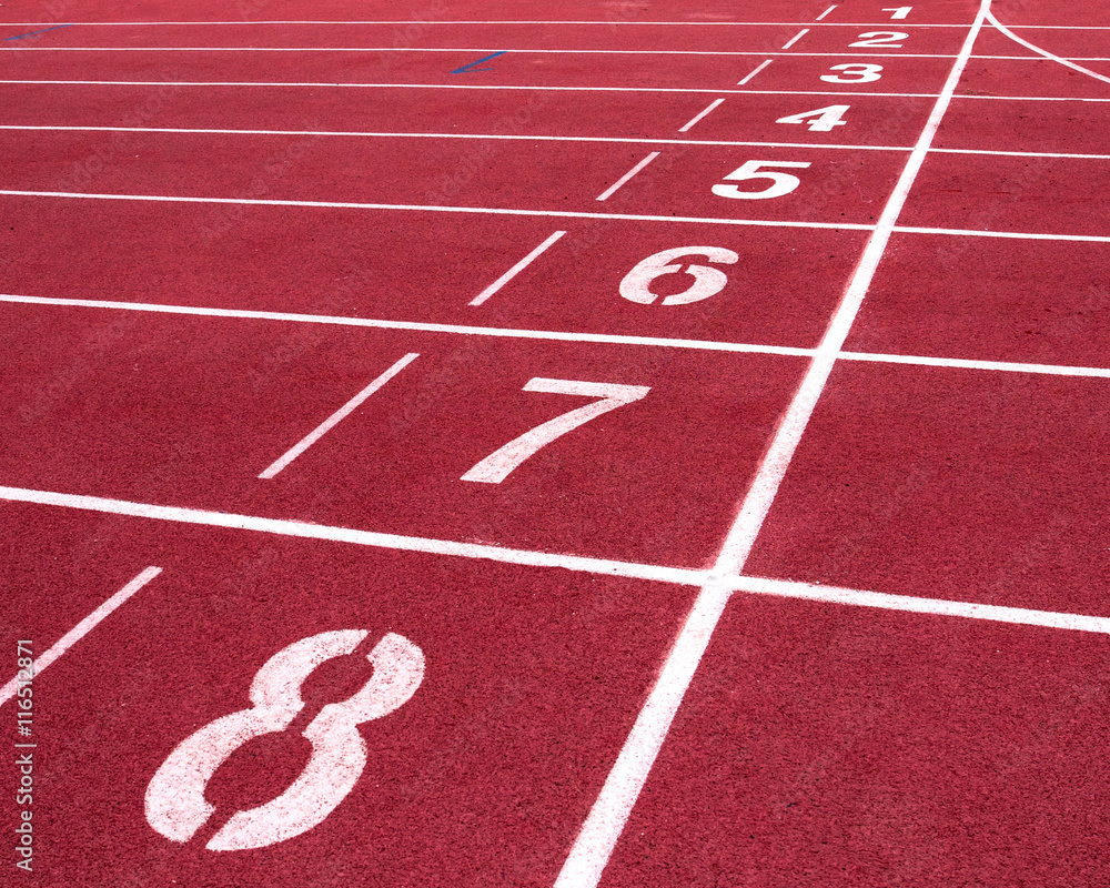 Red running track on the athletic stadium.
