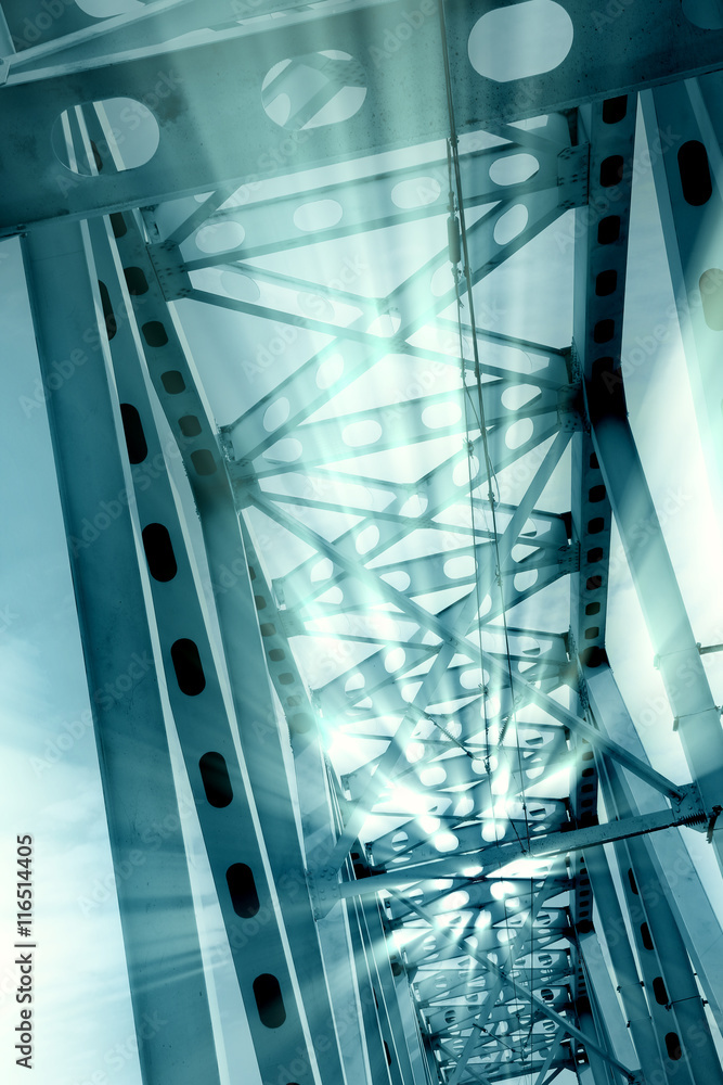 Naklejka premium Railway metal bridge perspective view. Ray lights glowing. Monochrome image