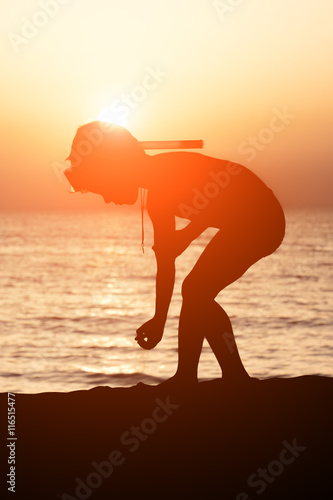little boy with mask and snorkel on background of sea sunset