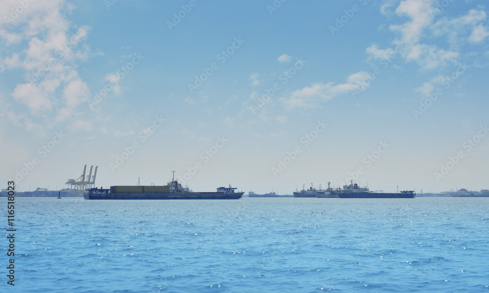 Cargo ship with shipping port over blue sea