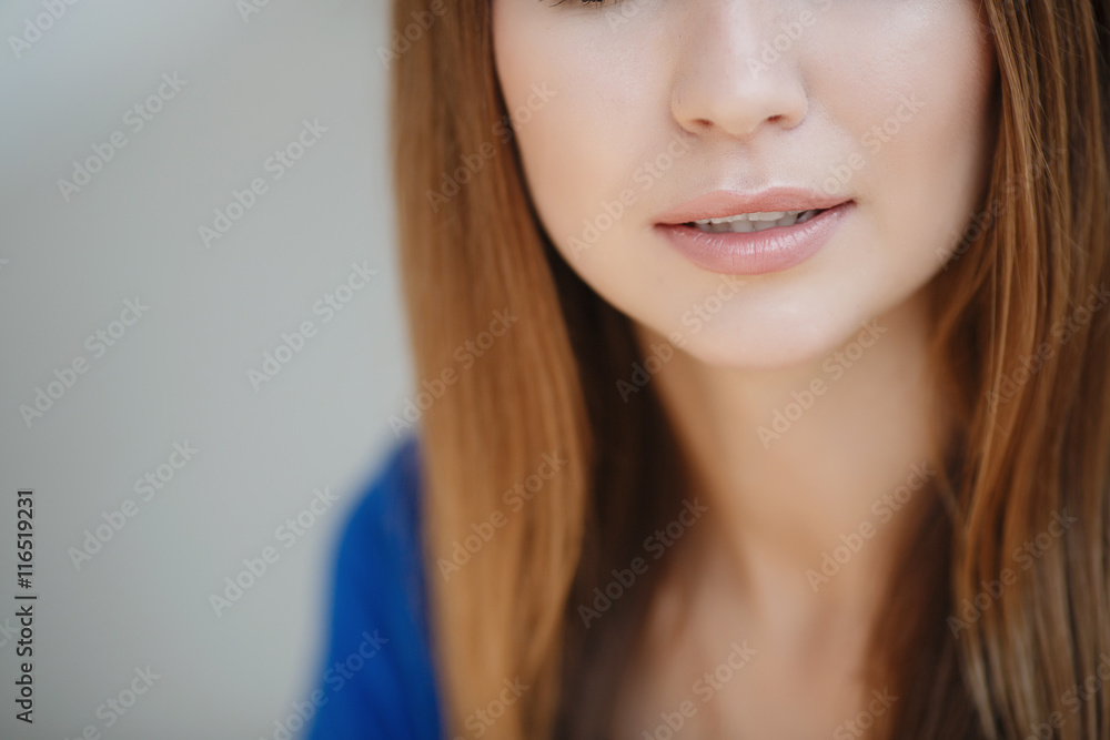 Beautiful young woman brunette with long straight hair,pretty smile,white straight teeth,wearing a blue summer dress,wears a gold chain on the neck,posing on light gray background Beautiful young woman brunette with long straight hair,pretty smile,white straight teeth,wearing a blue summer dress,wears a gold chain on the neck,posing on light gray background