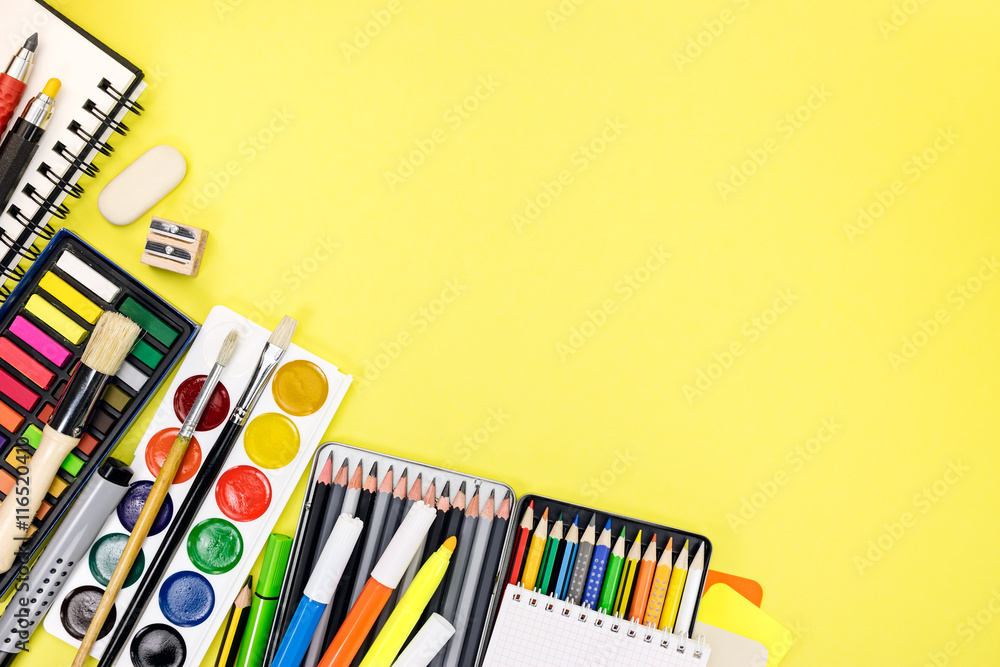 Fototapeta premium writing desk with colorful stationary and office supplies for ed