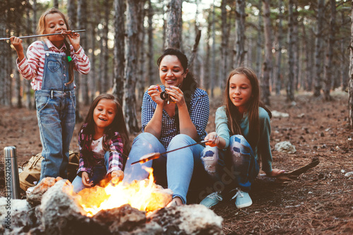 Children by the fire in autumn forest