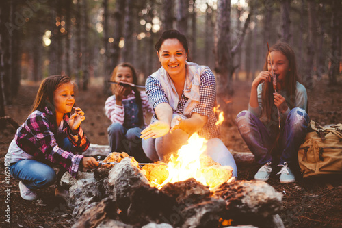 Children by the fire in autumn forest