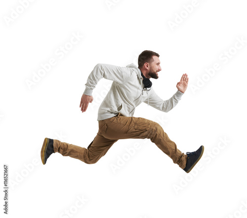 Young bearded man in mid-air jump over white background