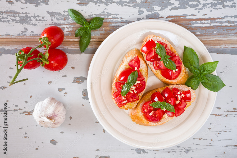 Italian bruschetta with tomato, basil and garlic on a plate Italian bruschetta with tomato, basil and garlic on a plate