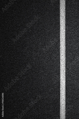Level asphalted road with a dividing white stripes. The texture of the tarmac, top view.