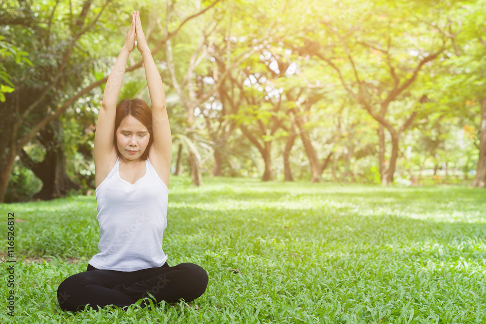 Young woman doing yoga in the park,Close up yoga relax in nature Young woman doing yoga in the park,Close up yoga relax in nature