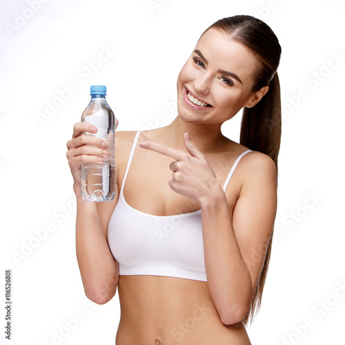 attractivesmiling woman holding bottle of water isolated on white