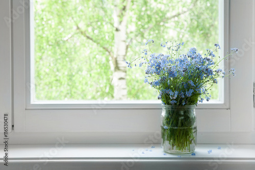Bouquet of flowers forget-me-nots on the window