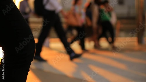 A lot of people are walking on the street. In the evening after work