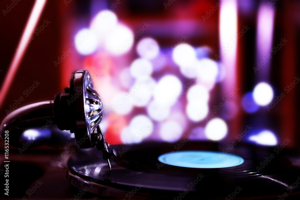 Turntable with vinyl record on dark blurred background Turntable with vinyl record on dark blurred background