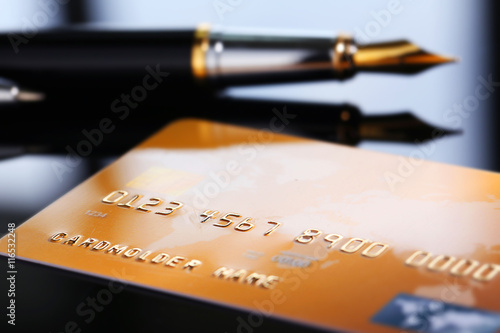 Credit card with pen, close up