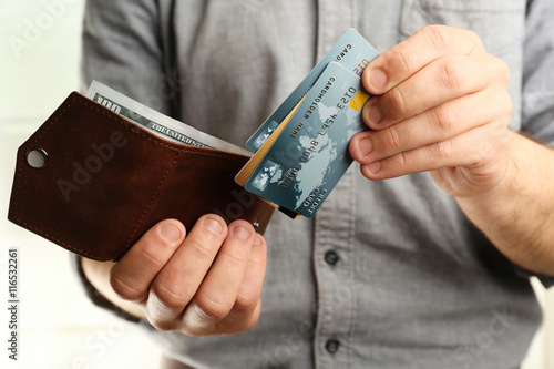 Man holding wallet with cre...
