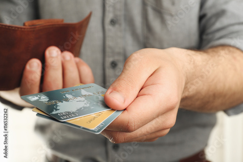Man holding wallet with cre...
