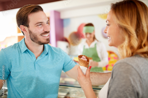 Man and woman in bakery taking ice cream