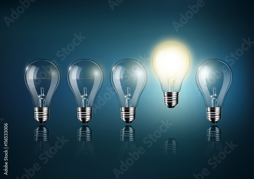 Glowing light bulb is among a lot of turned off light bulbs on dark blue background , concept idea , Transparent Vector