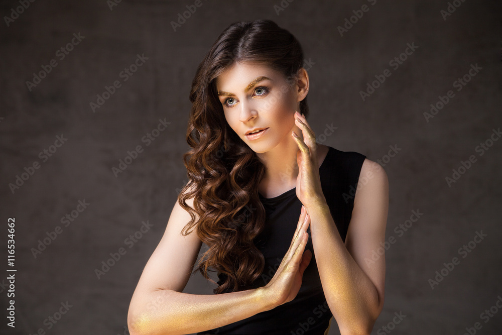 Fashion brunette with long wavy hair looking away Fashion brunette with long wavy hair looking away