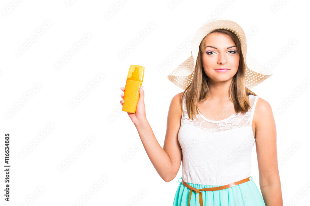 Cute young girl in summer clothes and beach hat using sunscreen isolated on white background. Cute young girl in summer clothes and beach hat using sunscreen isolated on white background.