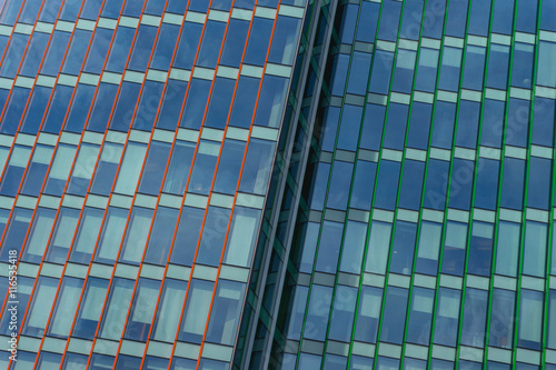 modern office building of glass and concrete. panoramic windows with background blue sky.