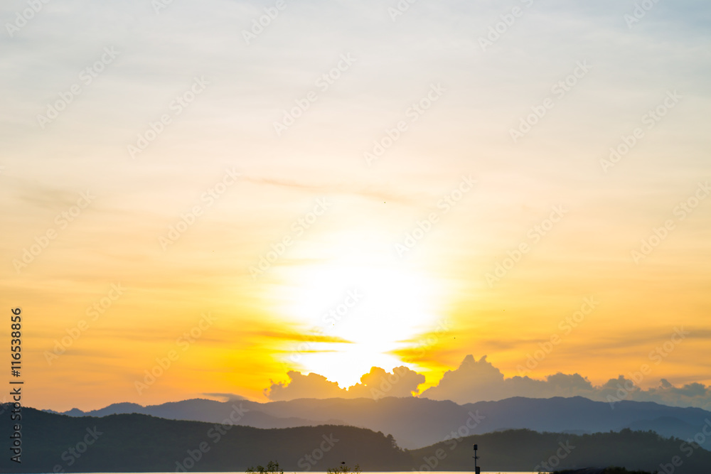 Mountain sunrise silhouette scene in reservoir background with m