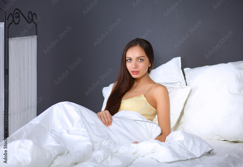 Pretty woman sitting in bed Pretty woman sitting in bed