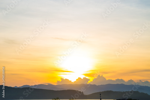 Mountain sunrise silhouette scene in reservoir background with m