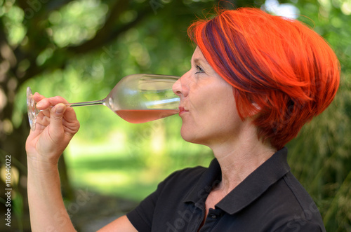 Redhead woman enjoying a glass of champagne