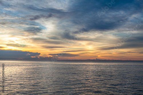 Photo of tropical sky at sunset.Seascape. Sun in the clouds over the sea. Horizontal picture. © KleverLevel
