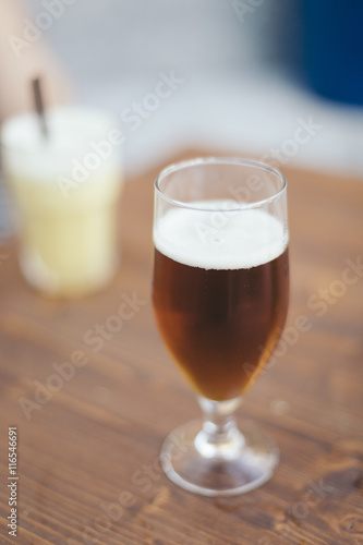 Blond fresh beer close up on a pub isolated on a wooden table