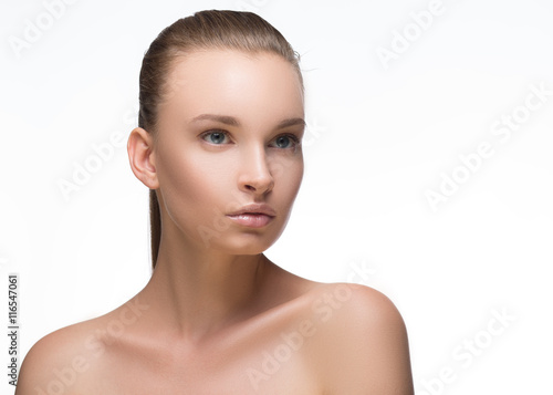 Beauty Girl. Portrait of Beautiful Young Woman looking at Camera. Isolated on White Background. Fresh Clean Skin
