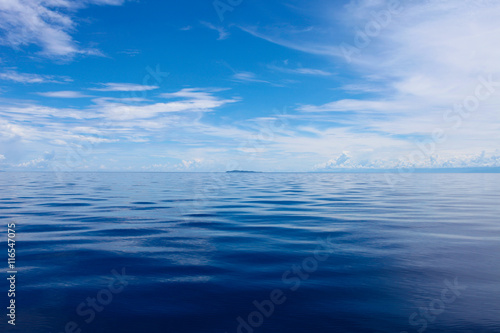 Photo of Blue Sea and Tropical Sky Clouds. Seascape. Sun over Water,Sunset. Horizontal picture.