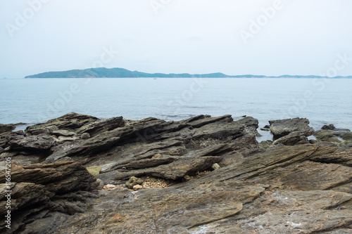 Rock on sea coastline with seascape view