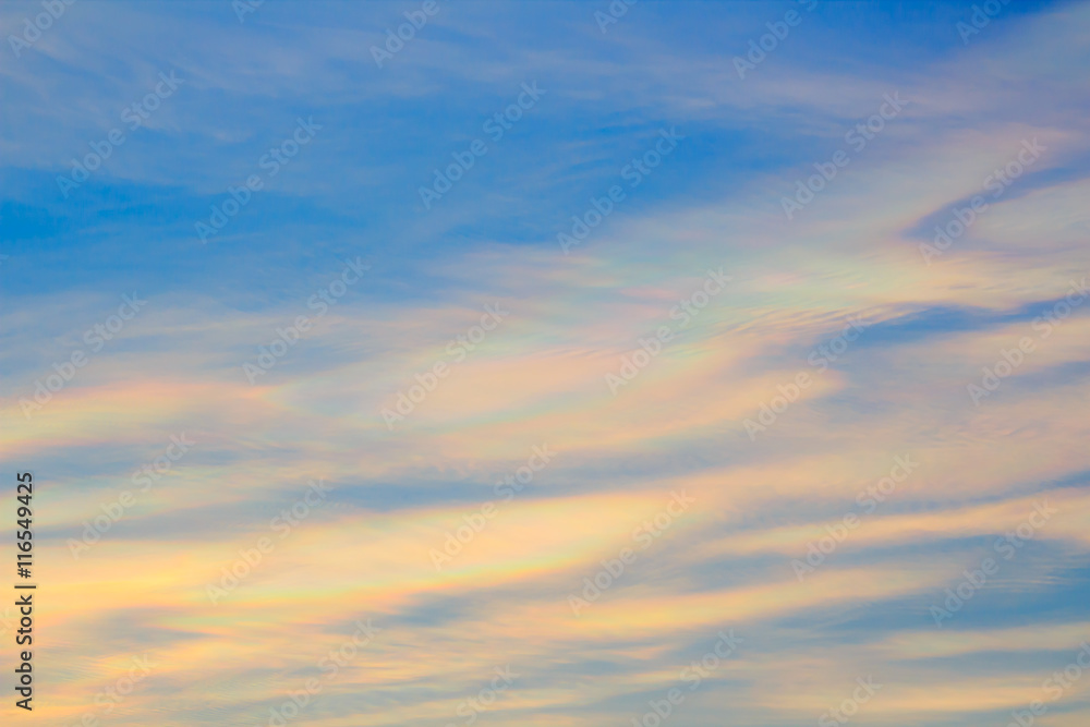 Colorful iridescent cloud, Beautiful Rainbow cloud. Blue sky at sunset, abstract background.
