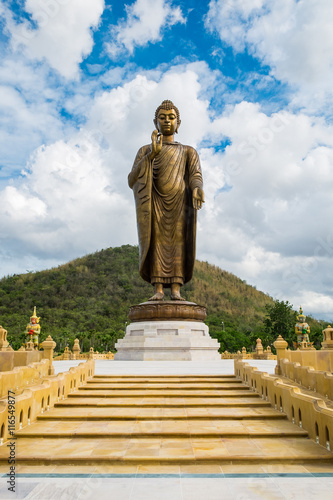 Giant golden buddha standing scenic in buddhist place at thipsukontharam temple, huai krachao, kanchanaburi, thailand