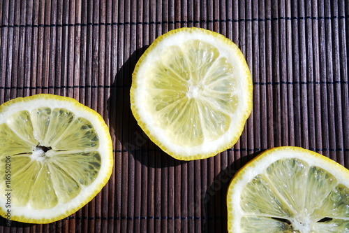Fresh lemon slices on wooden table. Top view 
